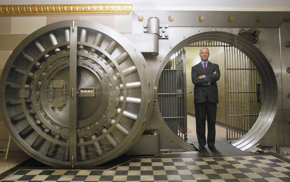 Daniel K. Walker, chairman and chief executive of Farmers & Merchants Bank, is seen inside the bank's vault in Long Beach.