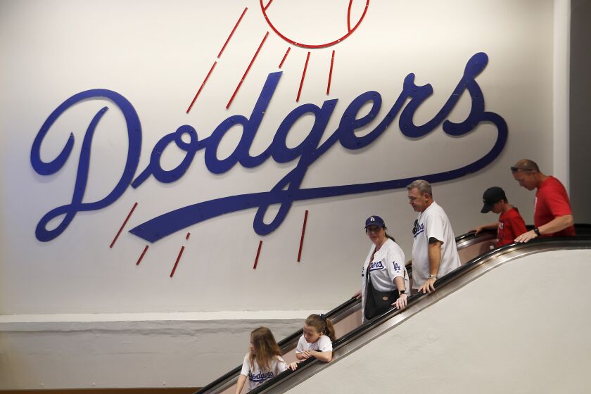 LOS ANGELES, CALIF. - AUG. 6, 2019. Dodgers fans take an escalator to the field level of Dodger Stadium before a game between the St. Louis Cardinals and the the Dodgers on Tuesday, Aug. 6, 2019. (Luis Sinco/Los Angeles Times)