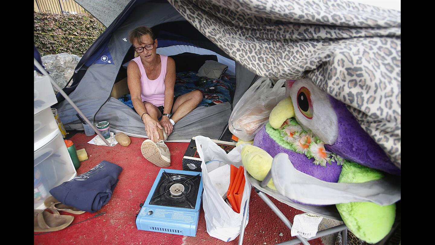 Lisa Weber talks Thursday about the tent she occupies in a Santa Ana River trail homeless encampment in Fountain Valley.