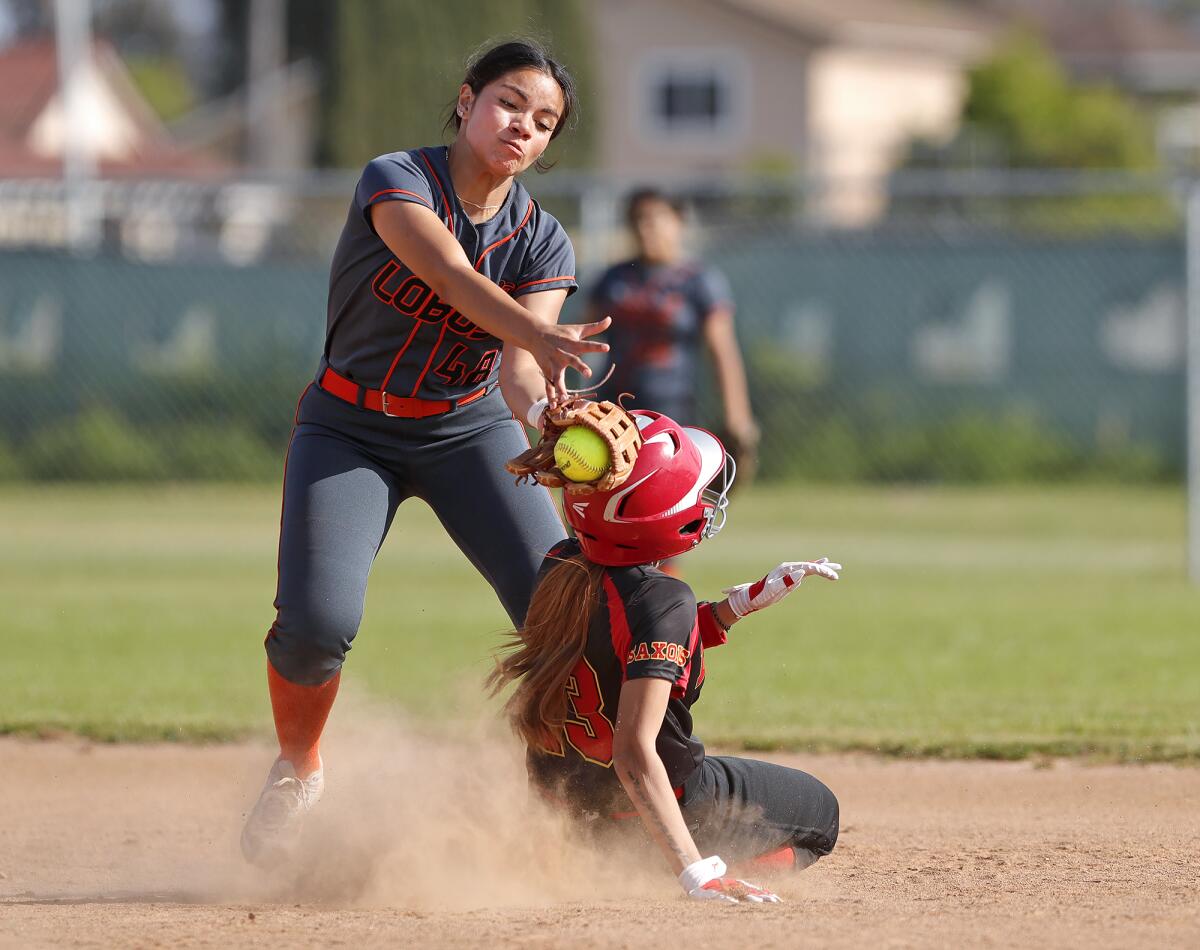 Los Amigos shortstop Valerie Villa (48) tags base runner Sierra Ponce during a softball game against Loara.