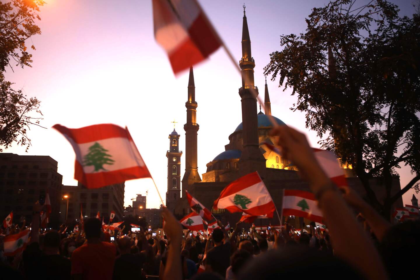 Lebanese demonstrators wave national flags as they take part in a protest in the capital Beirut, outside the Mohammad al-Amin mosque in the downtown district's Martyr's Square on October 19, 2019. - Tens of thousands of Lebanese people took to the streets today for a third day of protests against tax increases and alleged official corruption despite several arrests by security forces. (Photo by Patrick BAZ / AFP) (Photo by PATRICK BAZ/AFP via Getty Images) ** OUTS - ELSENT, FPG, CM - OUTS * NM, PH, VA if sourced by CT, LA or MoD **