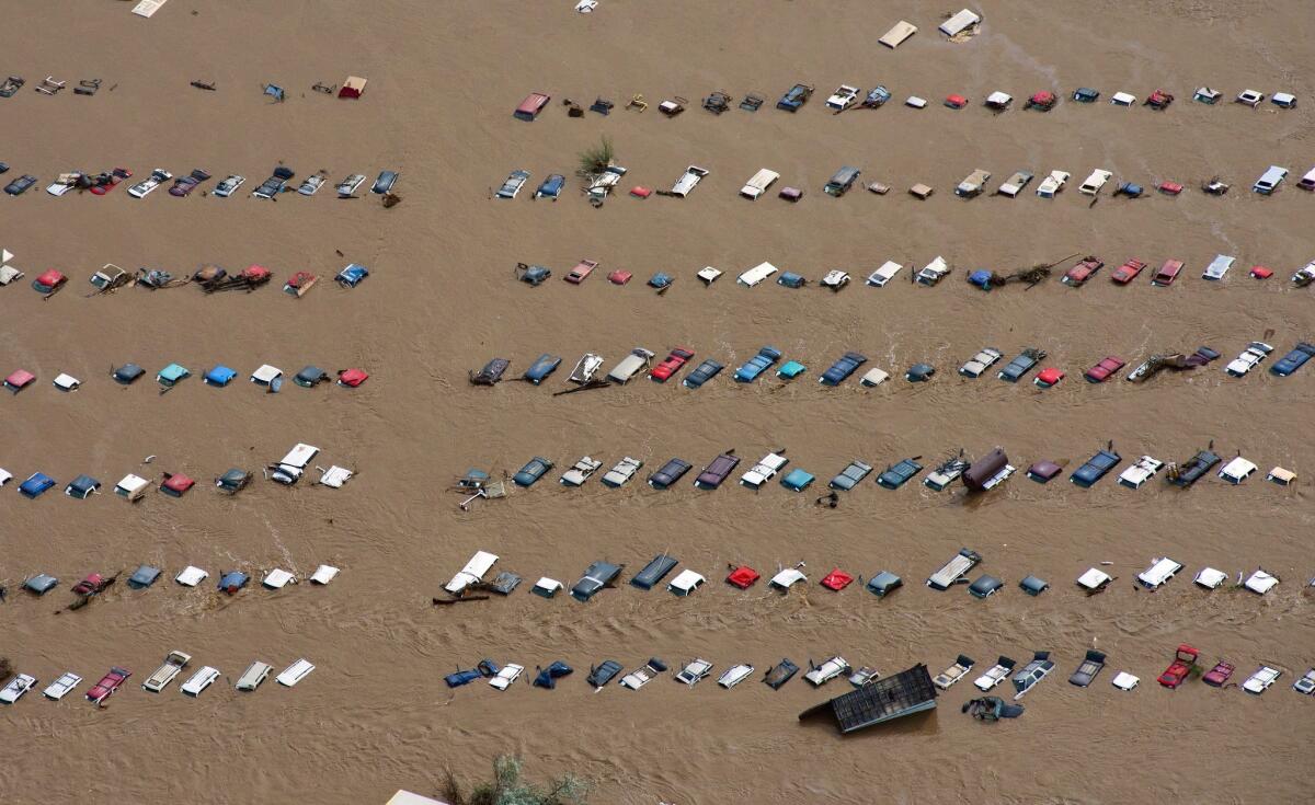 A field of parked cars and trucks sits partially submerged near Greeley, Colo., as rivers flood into towns and farms miles from the Rockies in September.