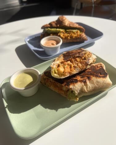 A breakfast burrito and breakfast croissant from the Moody Vegan Cafe