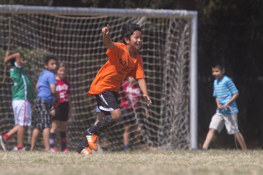 Davis' Jonathan Cheng celebrates after scoring against Whittier during the boys' 5-6 Gold Division championship game of the Daily Pilot Cup Sunday afternoon.