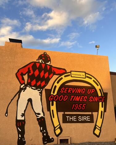 The exterior of the Sirehas a painting of a jockey next to a giant horseshoe