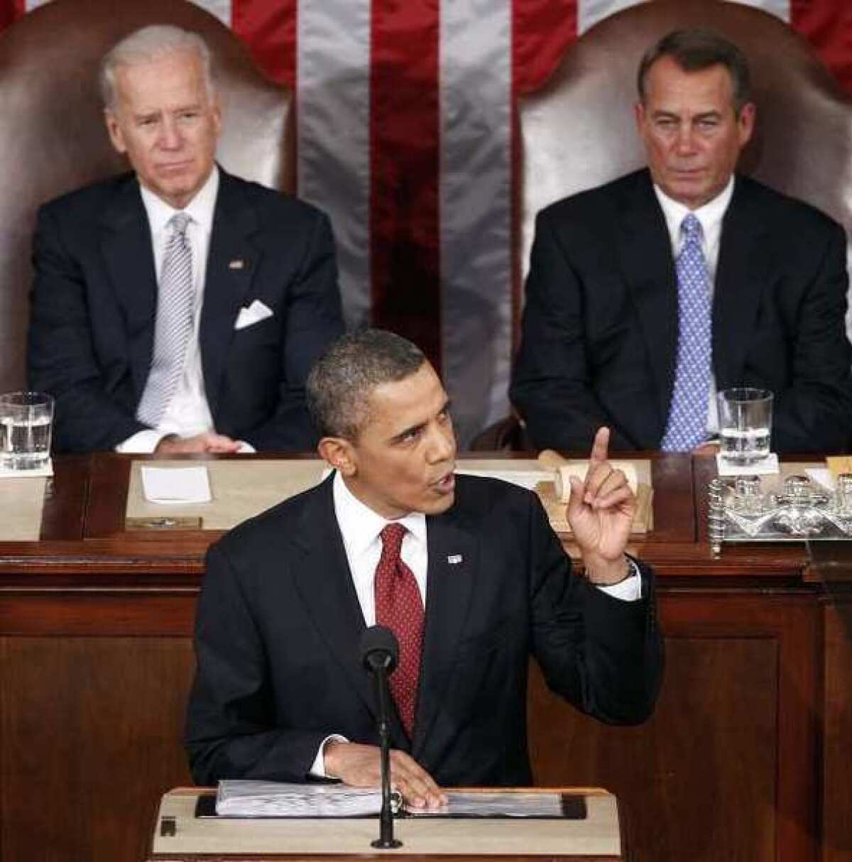 President Barack Obama delivers the State of the Union address as Vice President Joe Biden, left, and House Speaker John Boehner of Ohio listen in the U.S. Capitol in Washington.