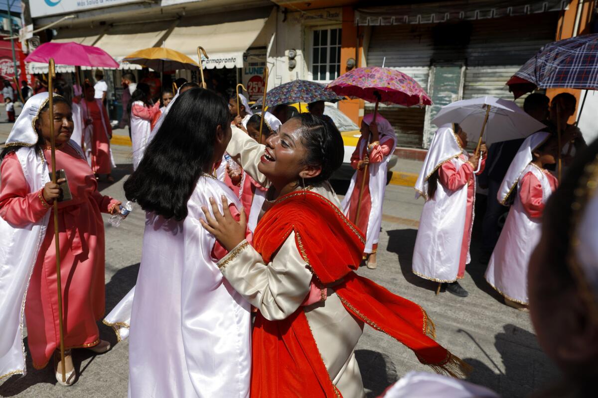 Wendy Cortes Rodriguez, 15, dances with friends in a calenda celebrating the Fiesta de la Candelaria, the presentation of the Christ Child, parading throughout the streets in Tlaxiaco, Oaxaca. (Gary Coronado / Los Angeles Times) More Photos