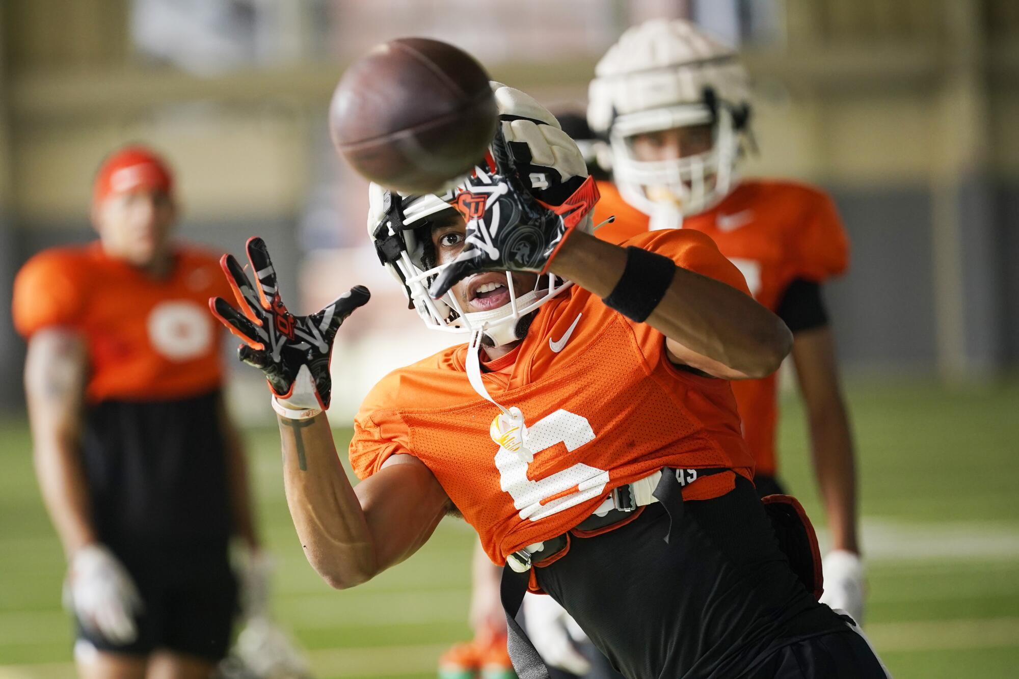 Oklahoma State's Stephon Johnson Jr. catches a pass in practice.
