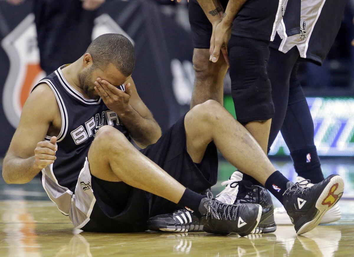 Spurs guard Tony Parker clutches his face after a second half collision in a 90-81 loss to the Utah Jazz.