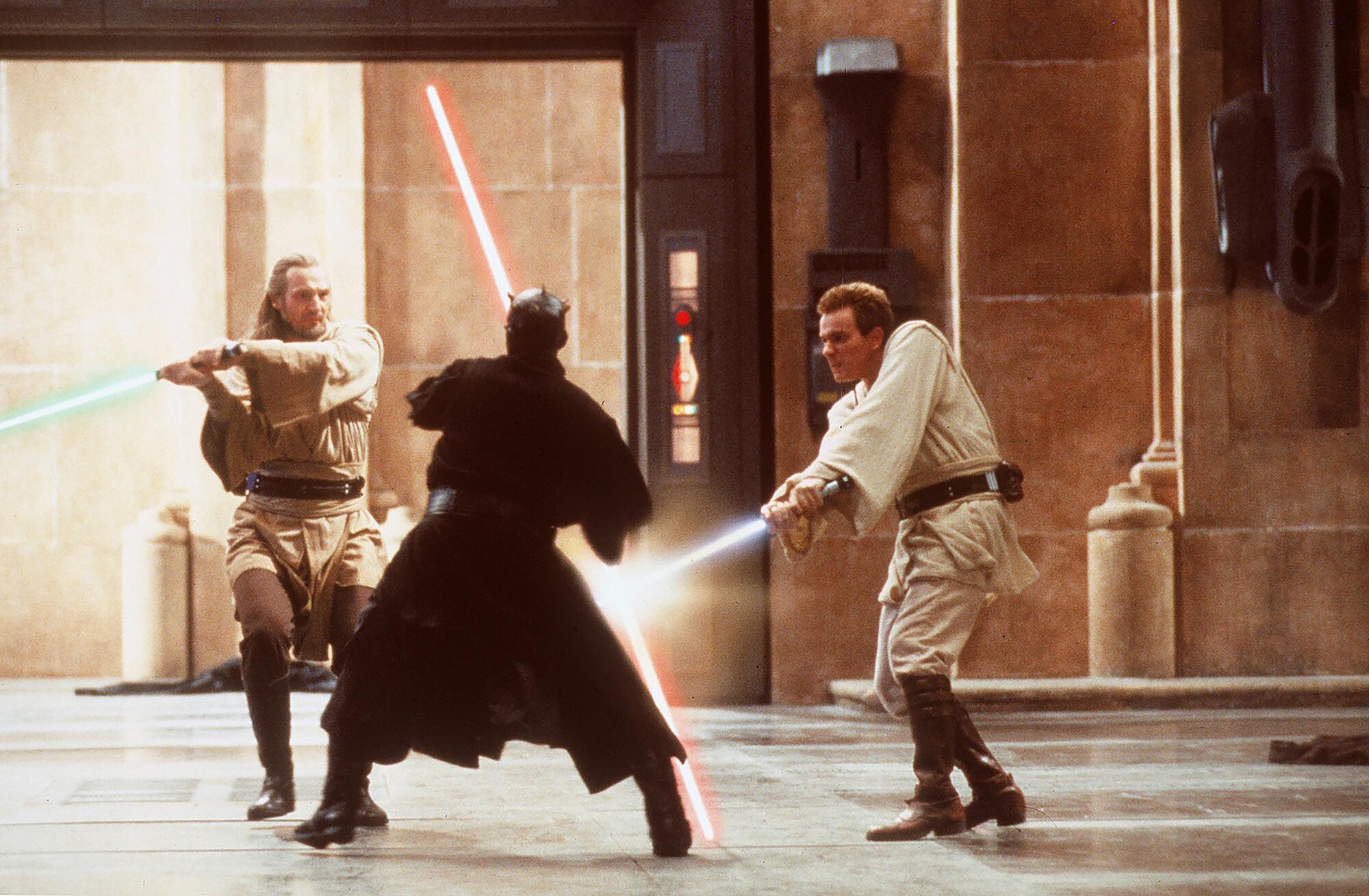 Three warriors face off in a lightsaber duel.