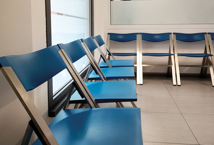 waiting room with chairs and feet of people