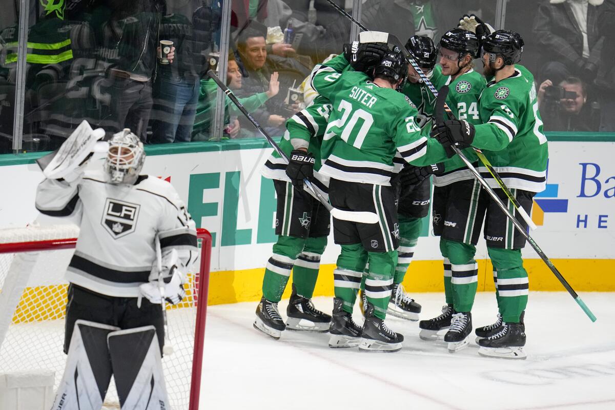 Dallas Stars players celebrate after a goal against Kings goaltender Cam Talbot during the Kings' loss Tuesday.