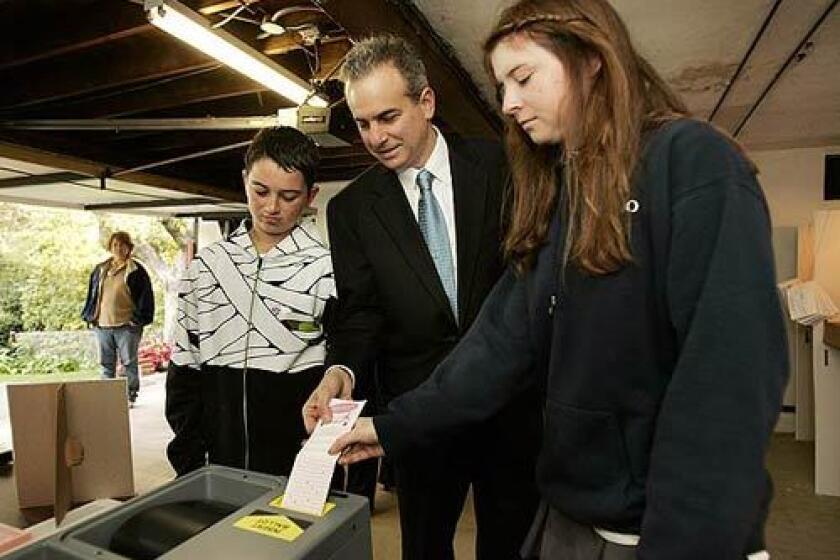 Jack Weiss, who is running for city attorney, casts his ballot in the garage of a Brentwood home. With him are his daughter, Mollie, 15, and son, Jacob, 13.