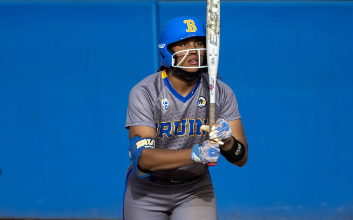 UCLA outfielder Maya Brady stares at her bat before stepping into the batters box during a game against Oregon State.