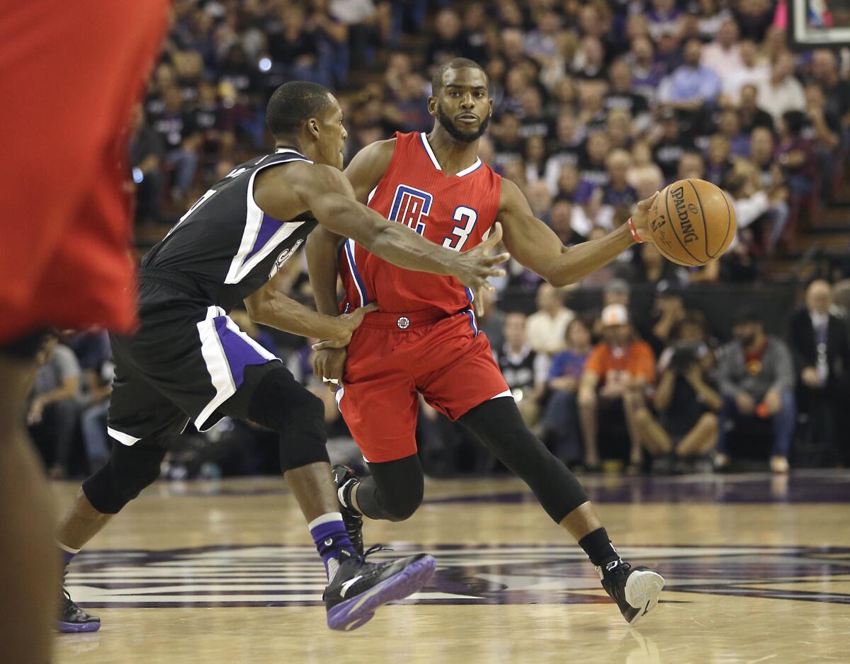 Clippers point guard Chris Paul makes a pass around Kings point guard Rajon Rondo in the first half.