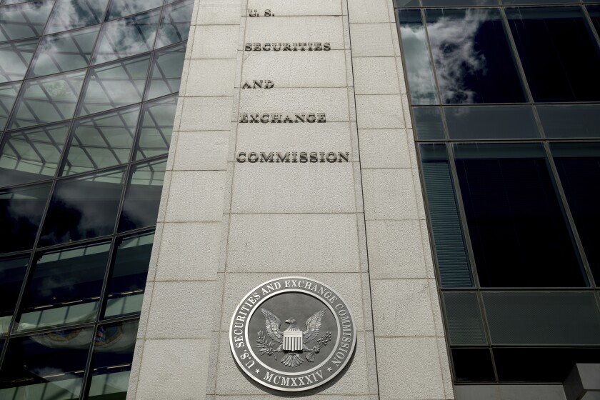 FILE - The U.S. Securities and Exchange Commission building in Washington is seen on Aug. 5, 2017. Chinese companies will have to disclose more information about audits and whether they are controlled by a government or else leave U.S. stock markets under a rule approved by securities regulators, Thursday, Dec. 2, 2021. (AP Andrew Harnik, File)