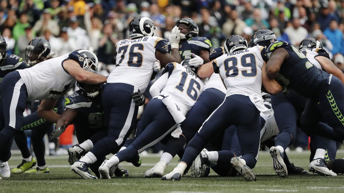 Rams offensive line surrounds quarterback Jared Goff (16) as he gets a first down late in the fourth quarter to seal the win over the Seattle Seahawks in their first meeting of the season.