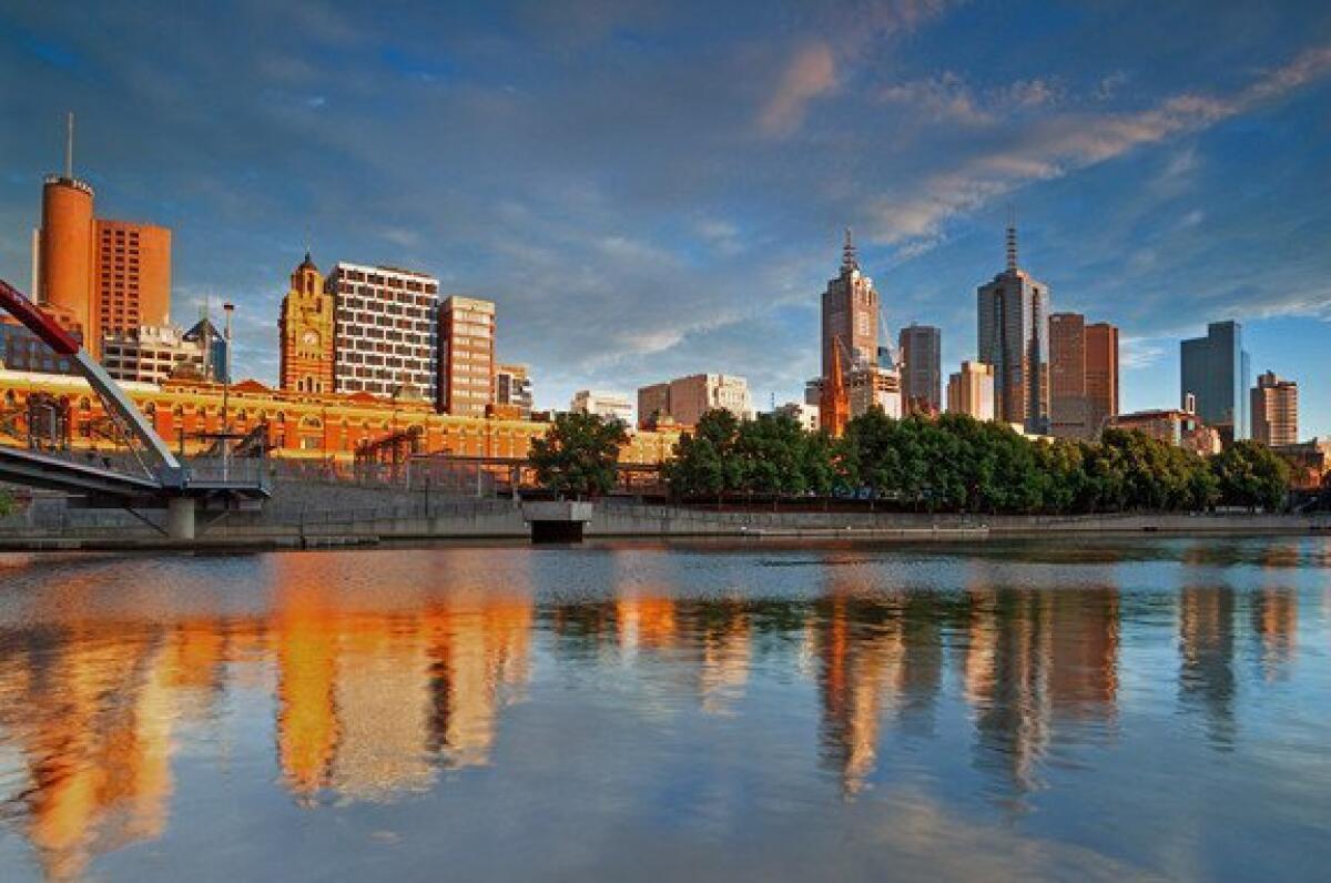 Skyscrapers in Melbourne's business district are reflected in the Yarra River.