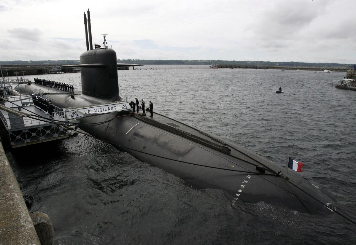 In this 2007 photo, French Marine officers wait atop Le Vigilant nuclear submarine at a military base near Brittany. Submarine crews may be among the last pockets of people unaware of how the coronavirus pandemic is turning life upside down.