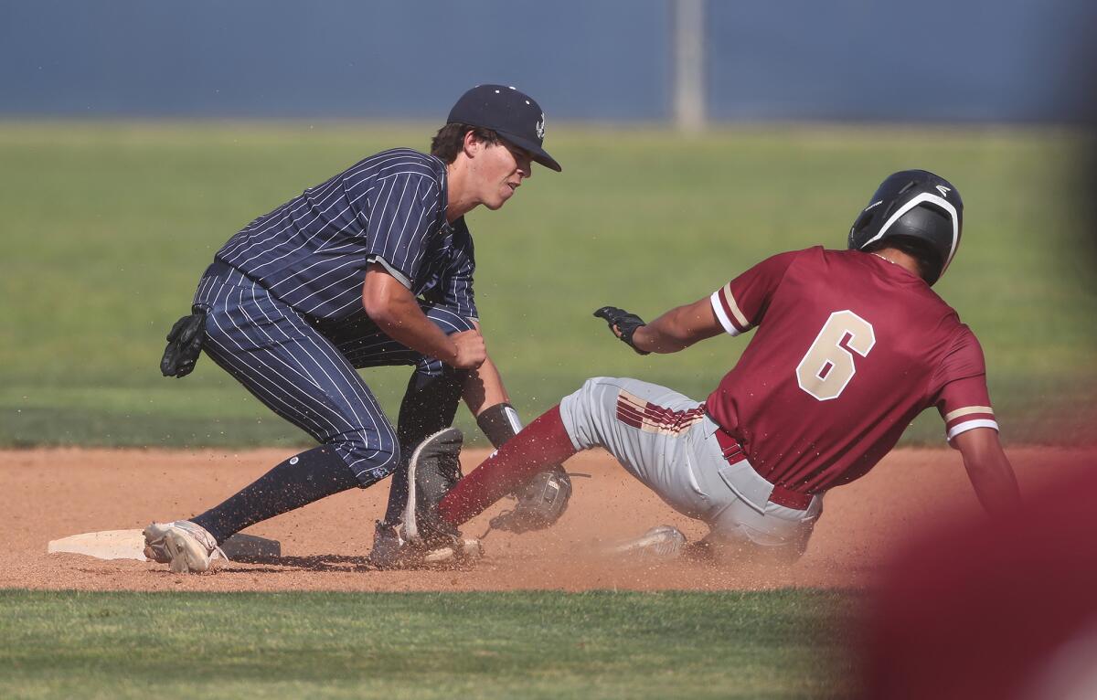 Newport Harbor's Austin Lueck tags out Oaks Christian's McKenzie Parks (6) in a CIF Southern Section Division 3 semifinal.