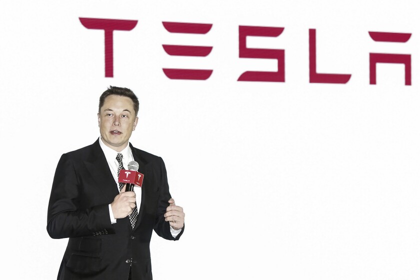Tesla CEO Elon Musk holds a press conference to introduce the auto-driving system upgrade for Chinese Tesla owners in Beijing, China on Oct. 23, 2015. Activists on Monday, Jan 3. 2022 are appealing to Elon Musk and Tesla Inc. to close a new showroom in China's northwestern region of Xinjiang, where officials are accused of abuses against mostly Muslim ethnic minorities. (Chinatopix via AP)