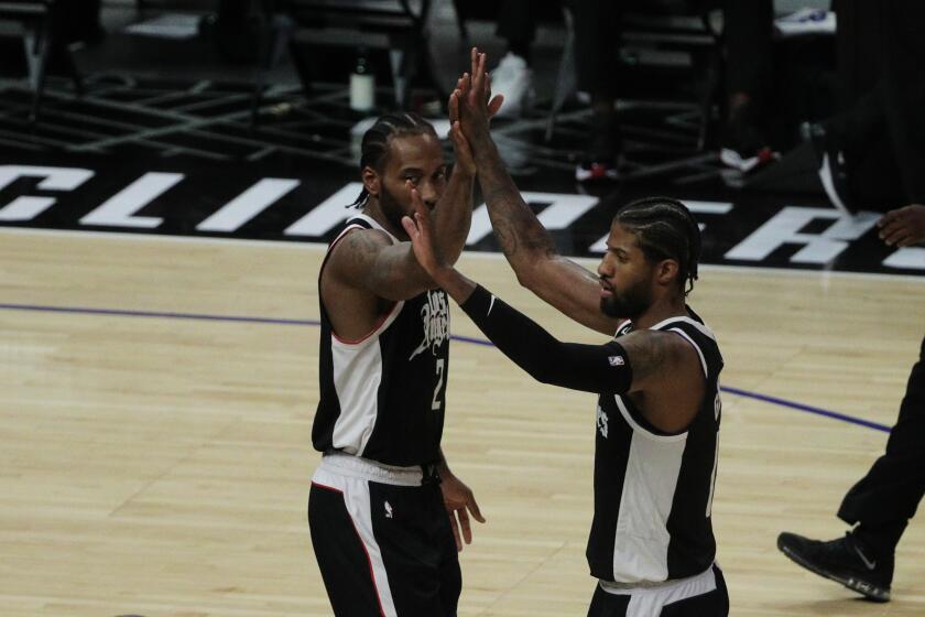 Clippers forwards Kawhi Leonard and Paul George celebrate during a playoff win over Utah.