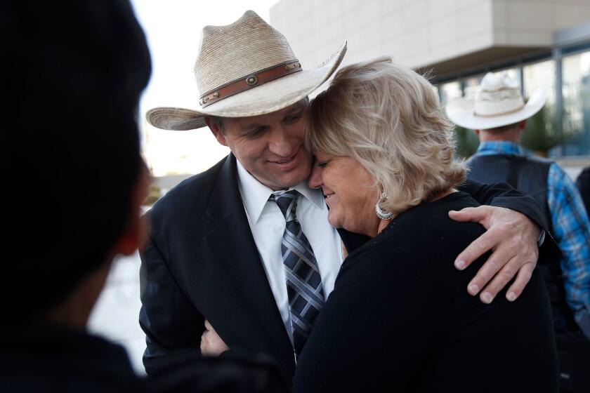 Ammon Bundy, left, hugs is aunt Lillie Spencer outside of a federal courthouse Wednesday, Dec. 20, 2017, in Las Vegas. Chief U.S. District Judge Gloria Navarro declared a mistrial Wednesday in the case against Cliven Bundy, his sons Ryan and Ammon Bundy and self-styled Montana militia leader Ryan Payne. (AP Photo/John Locher)
