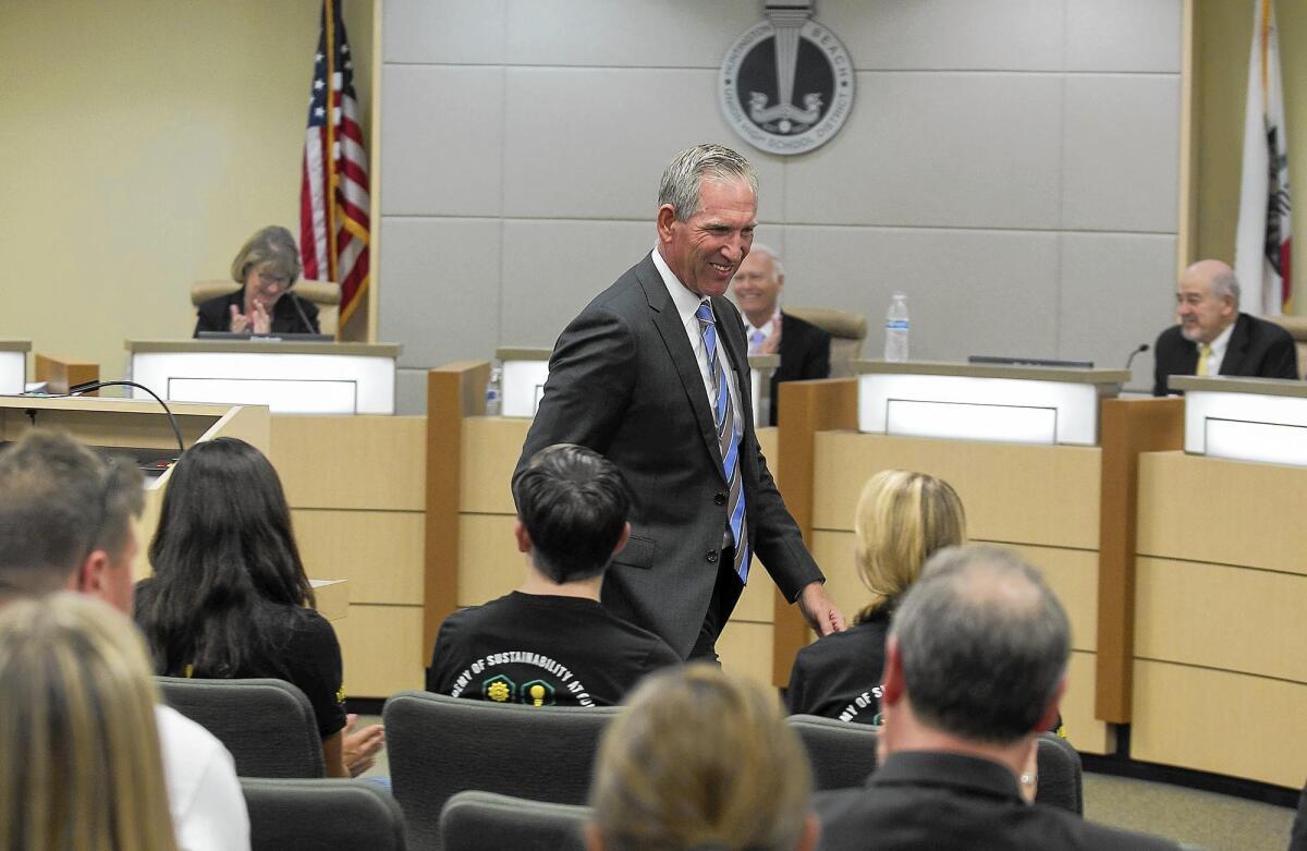 Clint Harwick smiles during Tuesday’s school board meeting, where his contract was approved as the new superintendent of the Huntington Beach Union High School District.