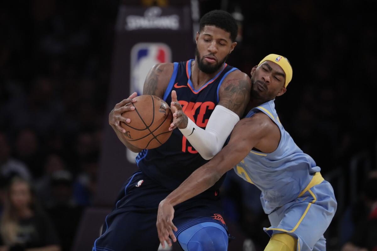 Lakers forward Corey Brewer tries to defend against Thunder forward Paul George during first half action.