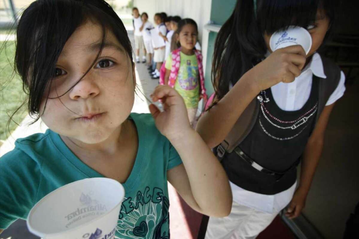 Kids line up for drinking water at school in Seville, Calif.
