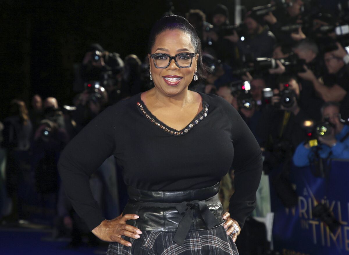 FILE - In this March 13, 2018, file photo, actress Oprah Winfrey poses for photographers upon arrival at the premiere of the film "A Wrinkle In Time" in London. Winfrey and the Smithsonian Channel are partnering up to highlight the racial disparities in the healthcare system through a new campaign and documentary. The network revealed on Thursday the Color of Care campaign to create a solution toward health equity. The campaign will follow the premiere of Winfrey’s “The Color of Care” documentary, which airs May 1. (Photo by Joel C Ryan/Invision/AP, File)