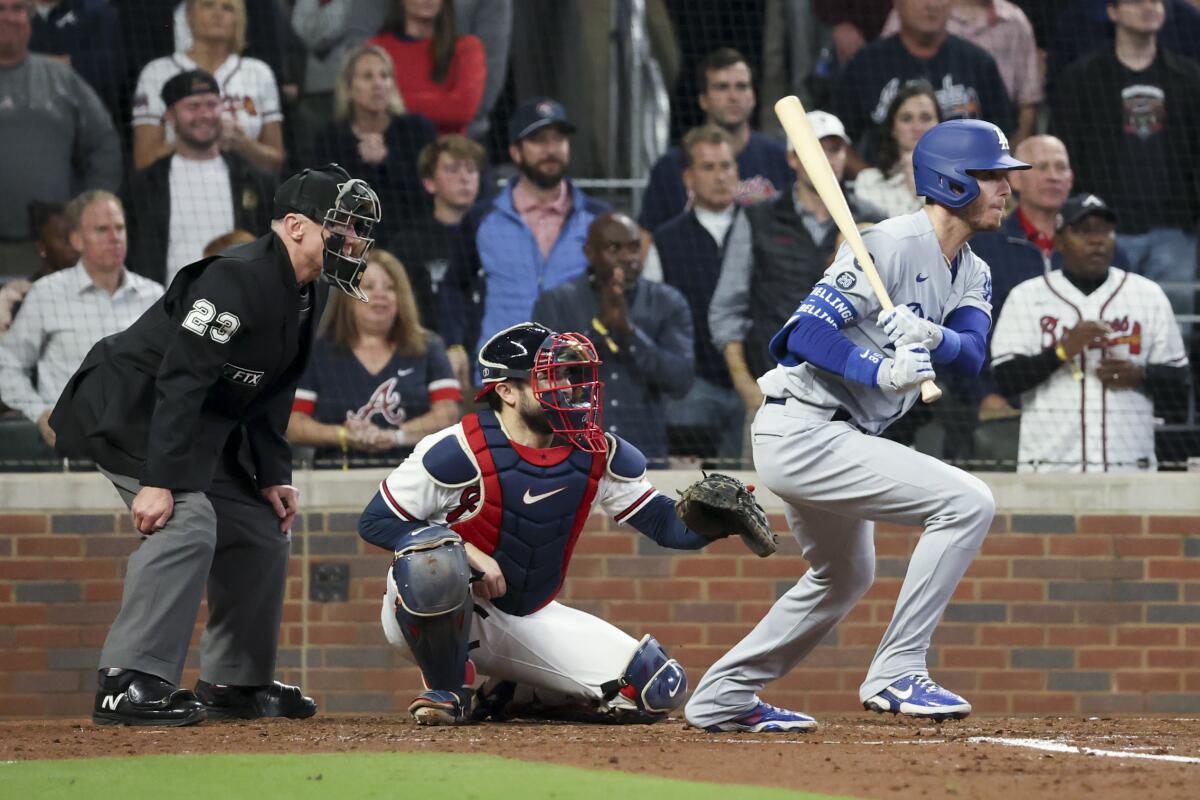 Cody Bellinger follows through on a run-scoring single for the Dodgers against the Braves.