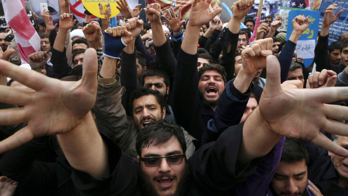Iranian demonstrators rally in front of the former U.S. Embassy in Tehran. The annual state-organized demonstration drew particular scrutiny as pressure increases on President Hassan Rouhani.