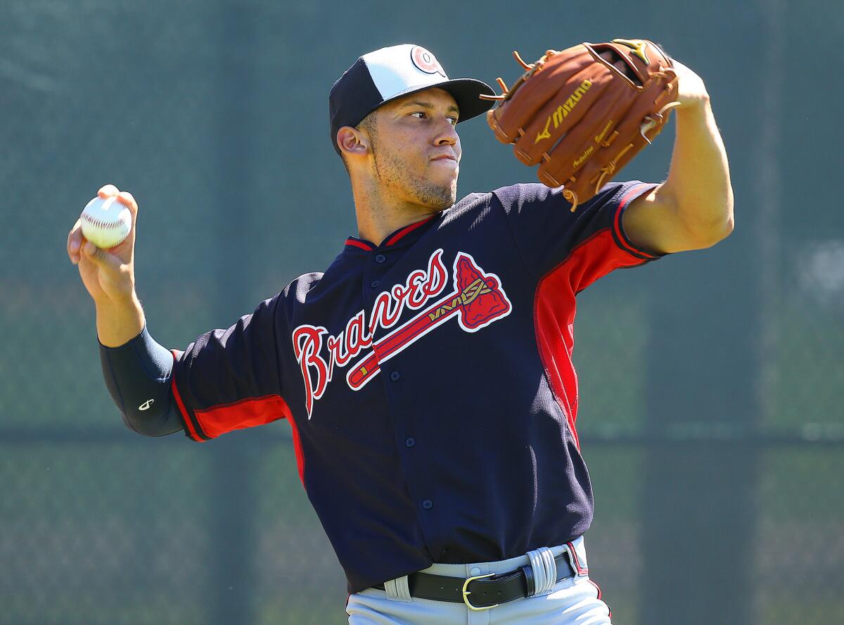Braves shortstop Andrelton Simmons takes part in a fielding drill during a spring training workout.