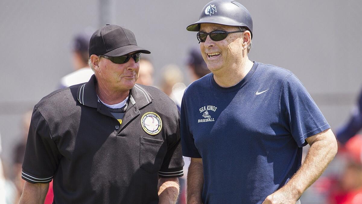 John Emme, right, shown talking with the umpire on April 11, 2017, said this year will mark the end of his Corona del Mar High baseball coaching career.