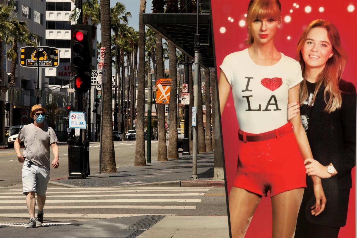 A  pedestrian wearing a mask approaches an image of Taylor Swift while walking down a deserted Hollywood Blvd.