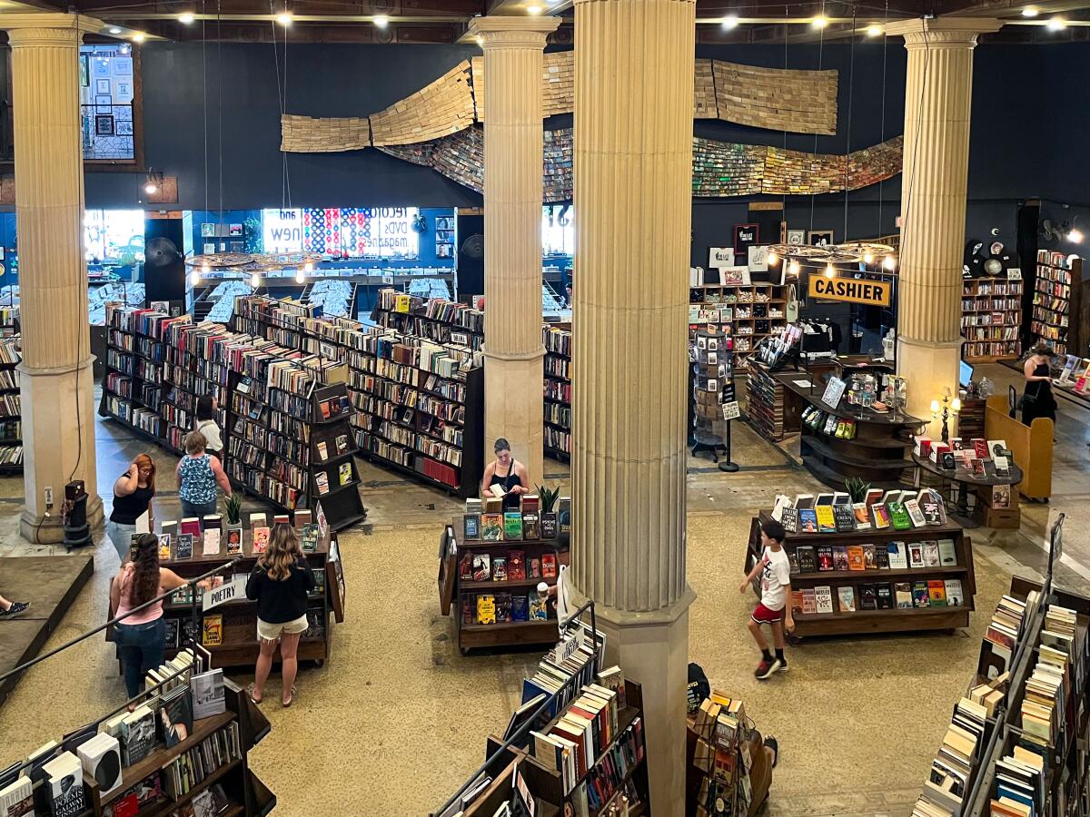 Visitors peruse through books and records inside of The Last Bookstore in downtown Los Angeles.