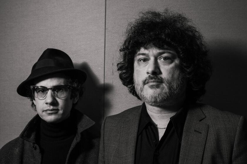 LOS ANGELES, CA - MARCH 16, 2023: Mars Volta's Omar Rodriguez-Lopez and Cedric Bixler-Zavala stand for a portrait at Silent Zoo Studios in Glendale, CA on March 16, 2023. (Emil Ravelo / Los Angeles Times)