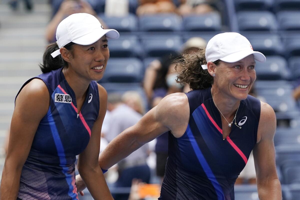 Shual Zhang, of China, left, and Samatha Stosur, of Australia, celebrate after defeating Coco Gauff and Catherine McNally, both of the United States, during the women's doubles final at the US Open tennis championships, Sunday, Sept. 12, 2021, in New York. (AP Photo/Elise Amendola)