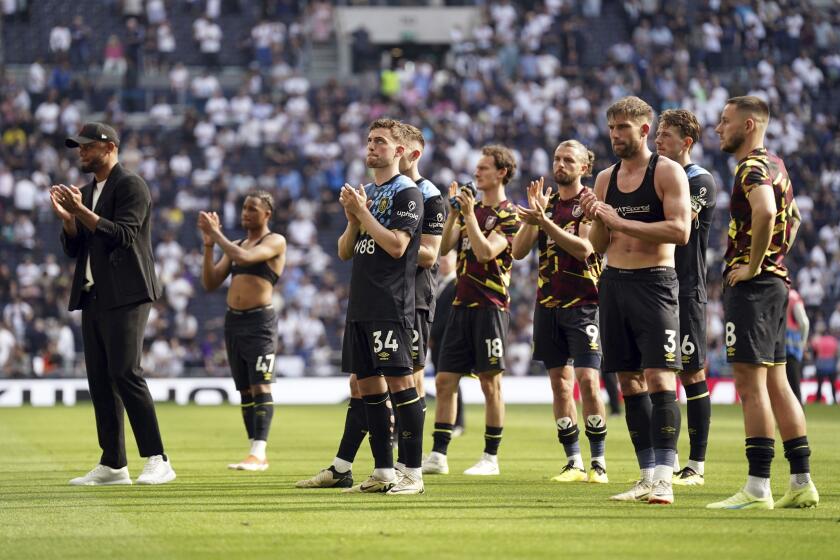 Burnley players alongside manager Vincent Kompany stand dejected after their relegations was confirmed, following the English Premier League soccer match between Tottenham Hotspur and Burnley, at the Tottenham Hotspur Stadium, London, Saturday May 11, 2024. (Adam Davy/PA via AP)