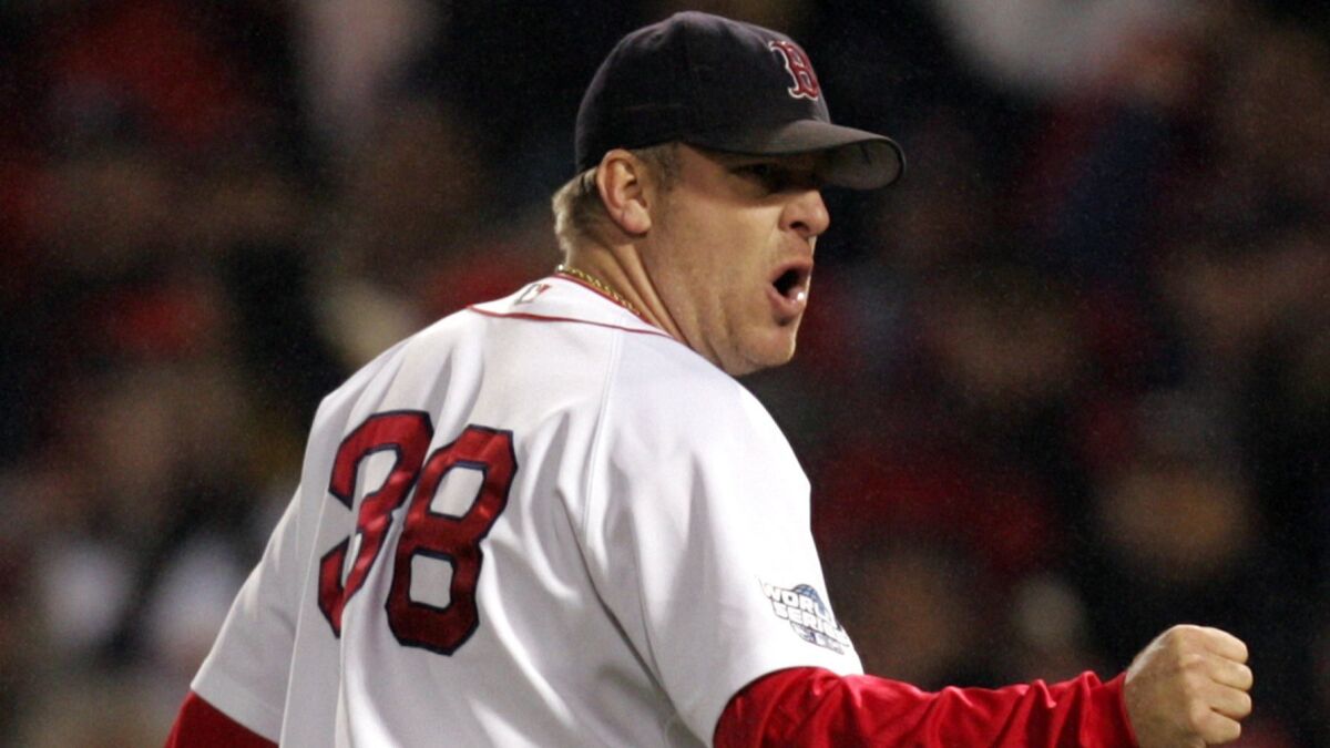 Boston Red Sox pitcher Curt Schilling celebrates an out during Game 2 of the 2004 World Series. Schilling was not invited to take part in a ceremony honoring players for that championship team Wednesday night.