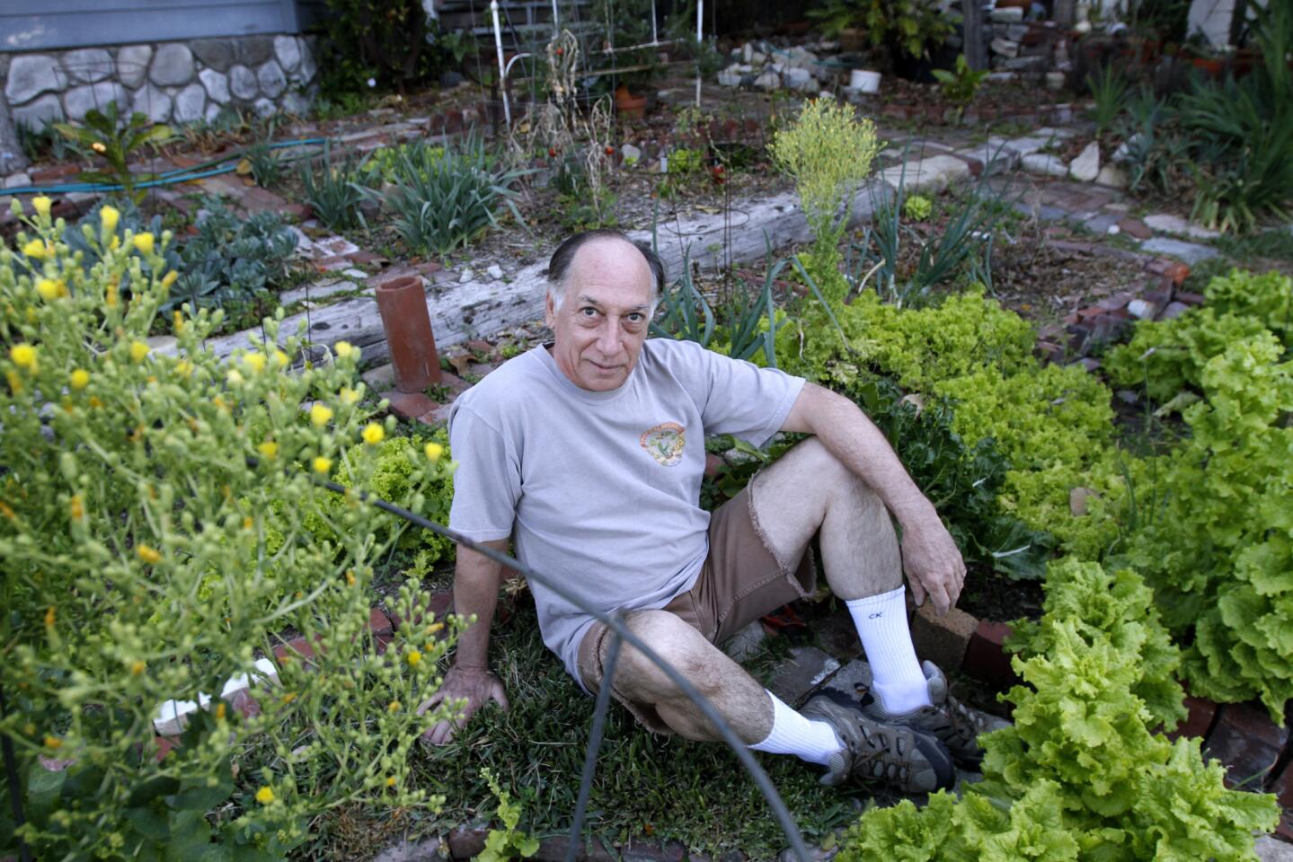 Jim Luna has had a garden in his front yard since he moved into his present home, some 40 years ago, in La Crescenta on Wednesday, March 12, 2014. Luna, who was a ballet dancer and computer tech, lets some of his fruits and vegetables go seed and then spreads that seed around his garden for the next year's crop.
