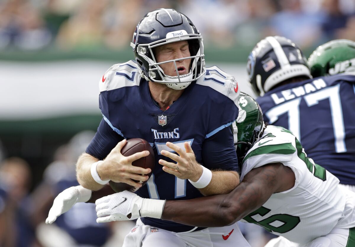 Tennessee Titans quarterback Ryan Tannehill (17) is sacked by New York Jets outside linebacker Quincy Williams (56) during an NFL football game, Sunday, Oct. 3, 2021, in East Rutherford, N.J. (AP Photo/Adam Hunger)