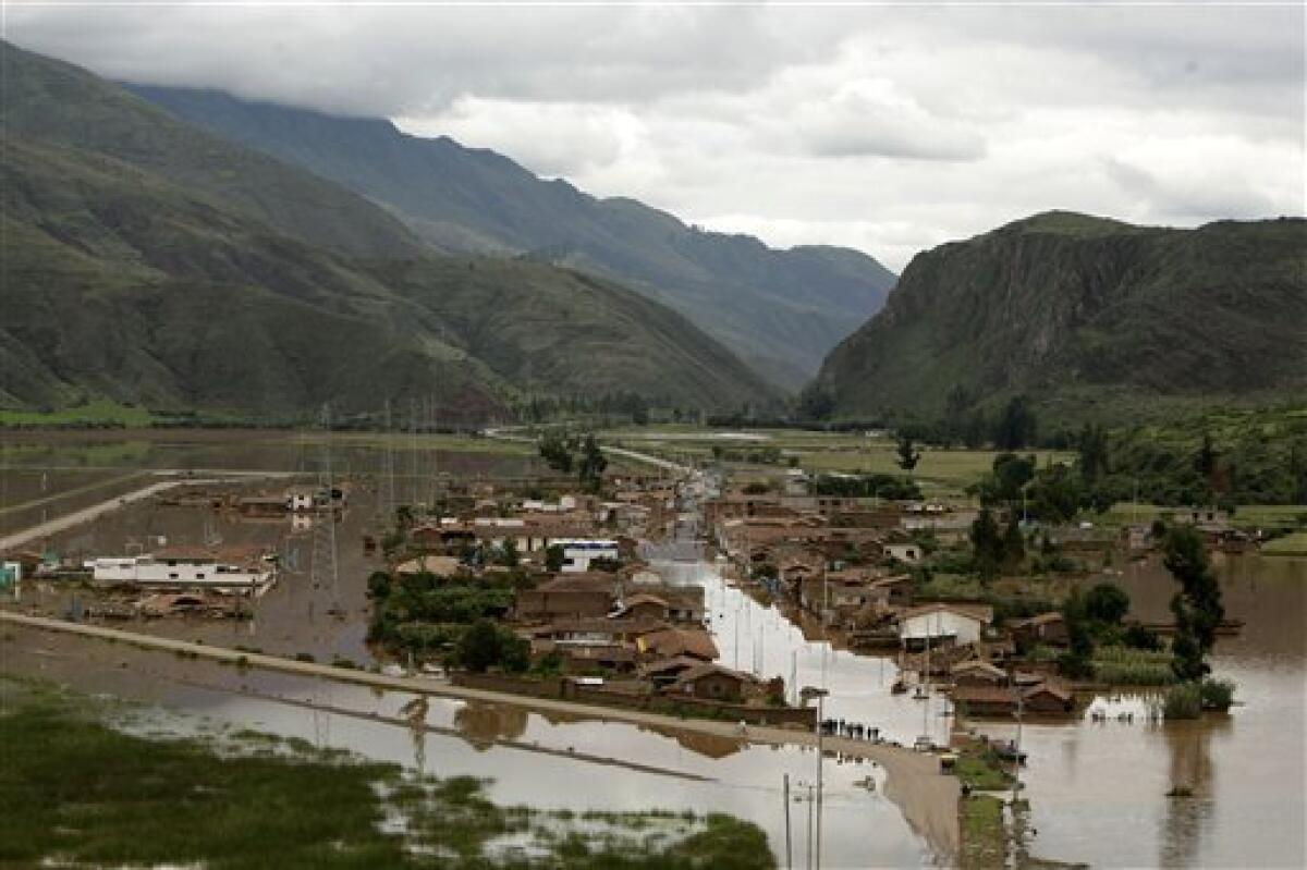 A flooded area is seen in this aerial view due to the overflow of the Huatanay river in Cuzco, Peru, Wednesday, Jan. 27, 2010. Heavy rains and mudslides in Peru have blocked the train route to the ancient Inca citadel of Macchu Picchu, leaving nearly 2,000 tourists stranded.(AP Photo/Martin Mejia)