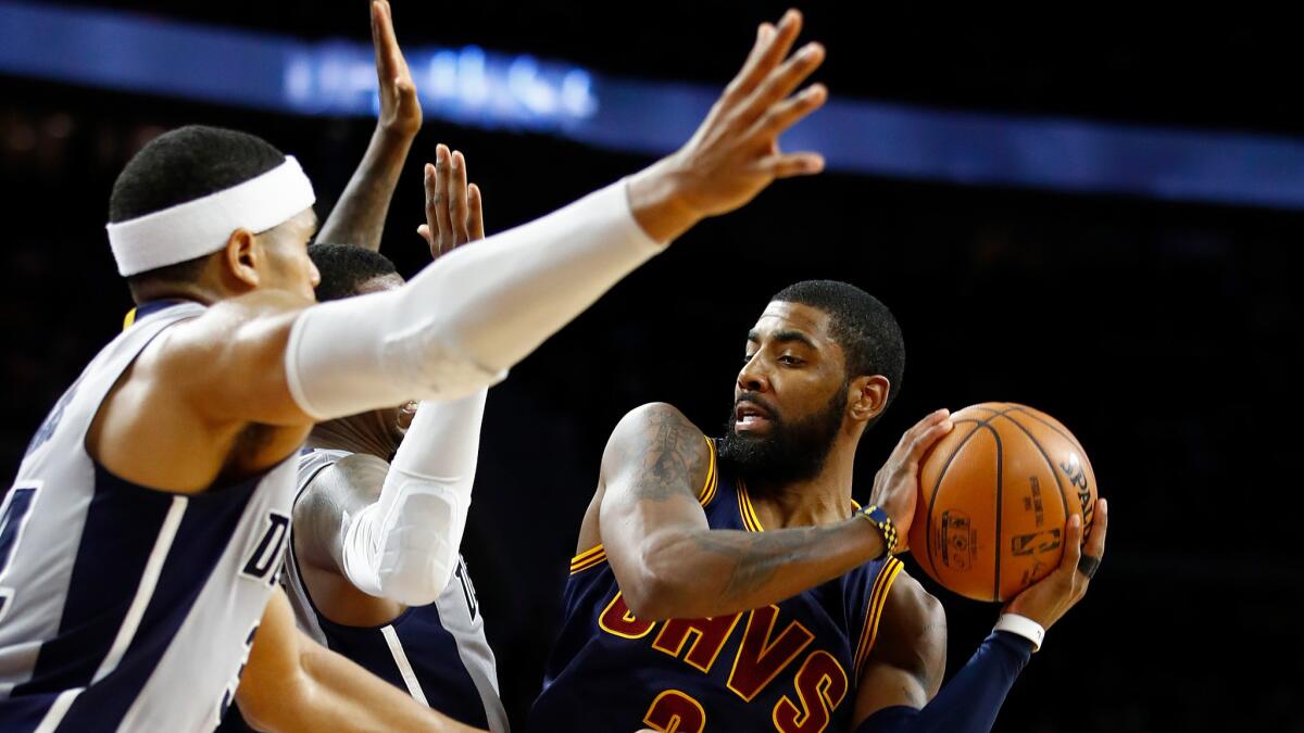 Cavaliers point guard Kyrie Irving looks to pass after driving down the lane against the Pistons during the second half Monday.