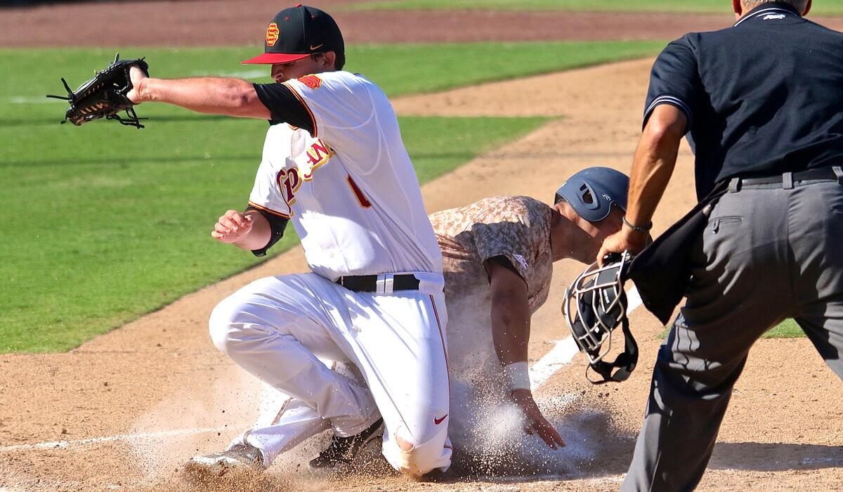 Virginia third baseman Kenny Towns slides in to score on a wild pitch while USC pitcher Kyle Davis tries to block the plate in the opening game of the NCAA baseball tournament's Lake Elsinore Regional on Friday.