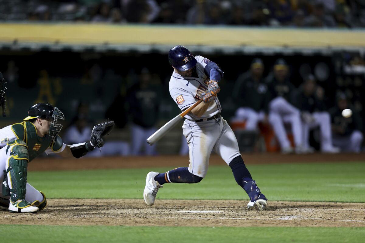 Houston Astros' Chas McCormick hits a home run in front of Oakland Athletics catcher Sean Murphy during the eighth inning of a baseball game in Oakland, Calif., Tuesday, May 31, 2022. (AP Photo/Jed Jacobsohn)