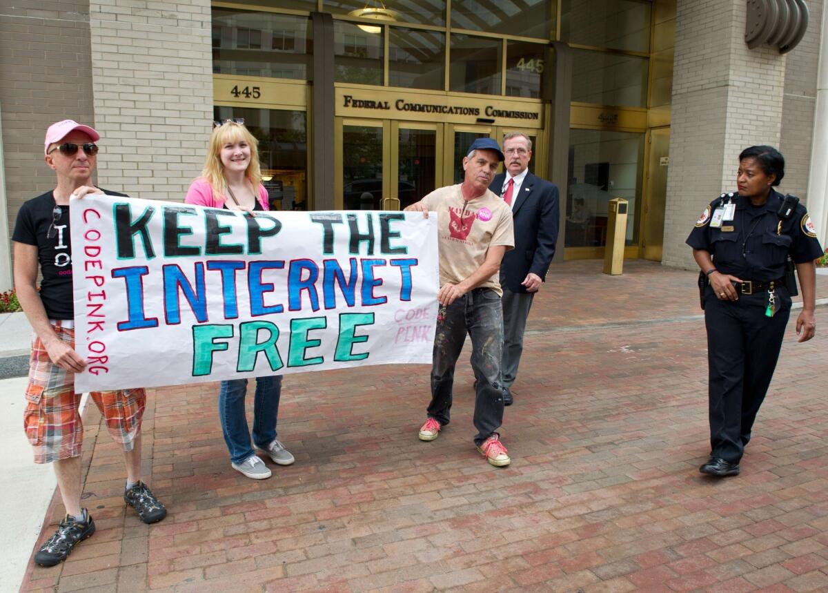 Protesters hold a rally outside the Federal Communications Commission's headquarters in Washington to support tougher Net neutrality regulations than the agency was considering.