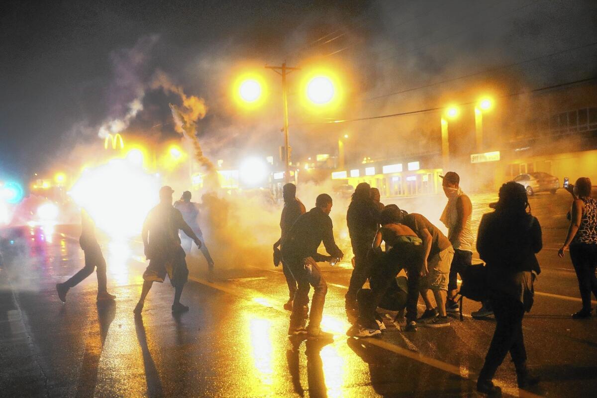 Police fire tear gas at Ferguson demonstrators on Sunday.