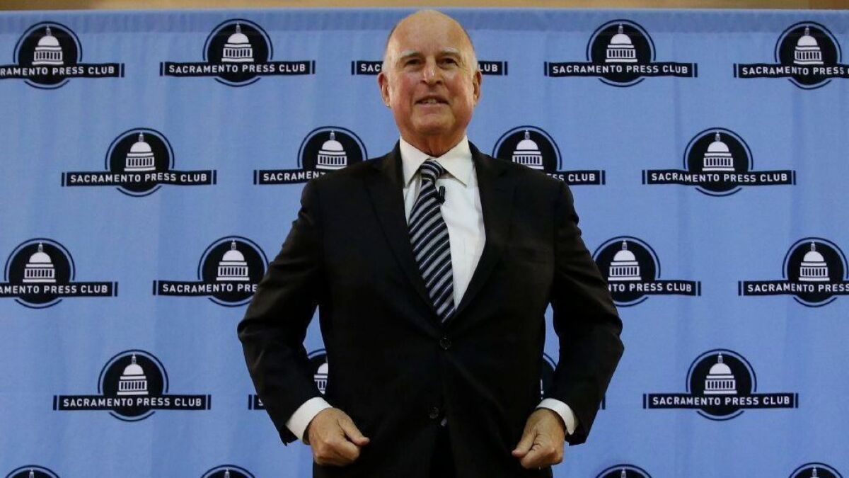 Gov. Jerry Brown smiles after his appearance at the Sacramento Press Club on Dec. 18.